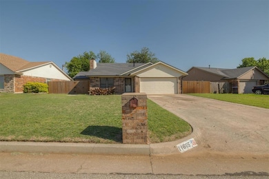 Ranch-style house with a garage, driveway, a chimn