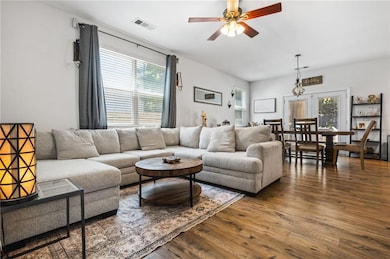 Living room with wood finished floors and ceiling fan