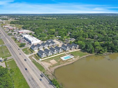 Aerial view featuring a forest view and a water vi