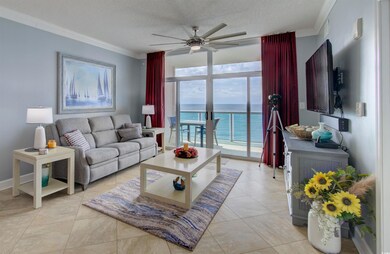 Living room featuring crown molding, a textured ceiling, a ceiling fan, expansive windows, and light tile patterned floors