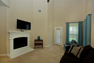 Light and bright family room with fireplace, vault