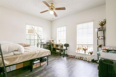 Bedroom featuring wood finished floors, multiple 