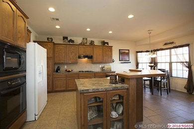 Warm cabinetry is enhanced with glass display cabi