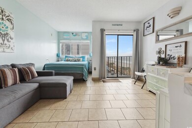 Bedroom with access to exterior, light tile patterned flooring, and a textured ceiling
