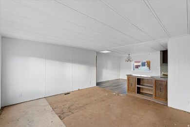 Unfurnished living room with wood walls