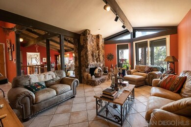 The living room opens to the outdoor deck that spa