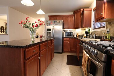 Tiled Kitchen with Granite Counters & Stainless Ap