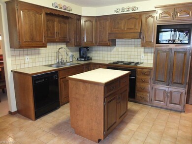 Fully applianced kitchen has center island.