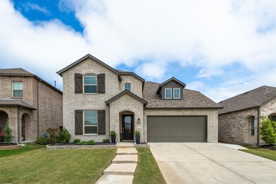 View of front facade featuring a front lawn and a garage