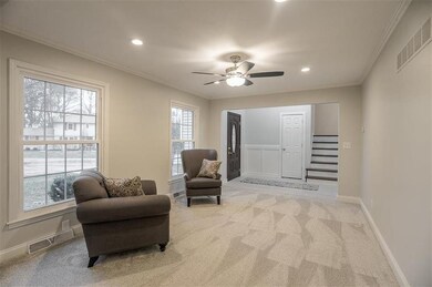 Living room just off the foyer and open to dining 