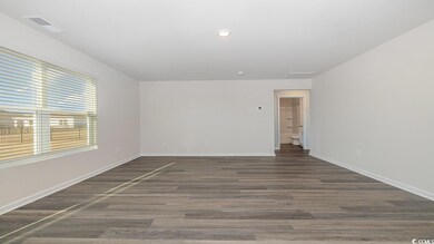 Empty room featuring dark hardwood / wood-style fl