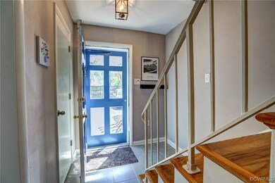 Foyer with tile, powder room and coat closet.