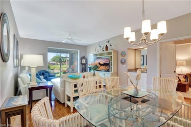 Dining room with ceiling fan with notable chandeli