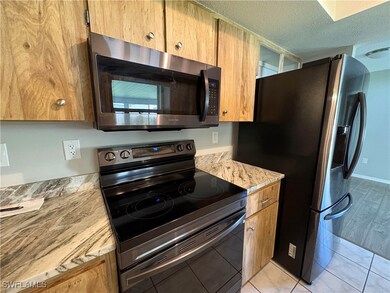 Kitchen featuring a textured ceiling, stainless st