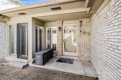 front entry with pavers and cement porch