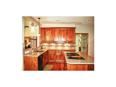 Open kitchen with lots of beautiful oak cabinetry 
