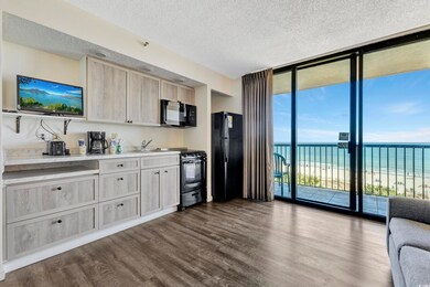 Kitchen featuring light countertops, dark wood-sty