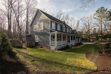 View of front of house with a front yard, fence, c