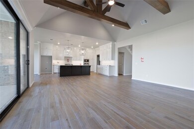Unfurnished living room featuring beam ceiling, ce
