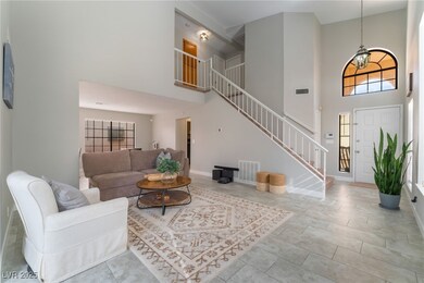 Living area with stairway, visible vents, and base
