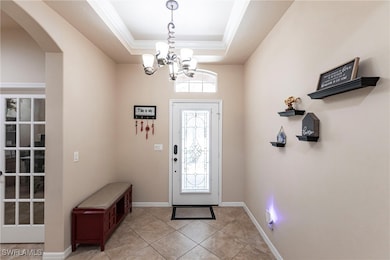 Entryway with arched walkways, light tile patterne