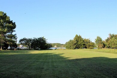 Long yard in the back of home to the water