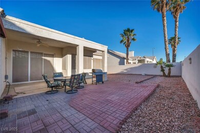 Fenced backyard featuring a ceiling fan, area for