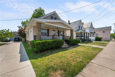 Bungalow-style home featuring a front lawn, a 1 car detached garage and covered front porch