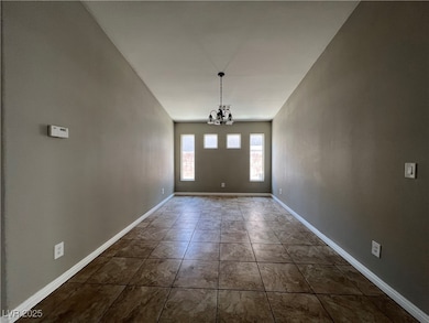 Unfurnished dining area with a chandelier and base