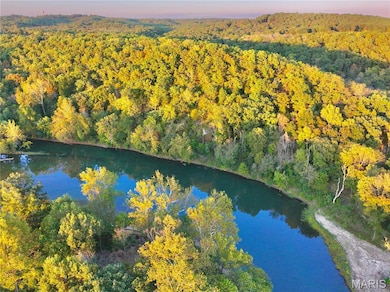Aerial overview of property's location with a nearby body of water