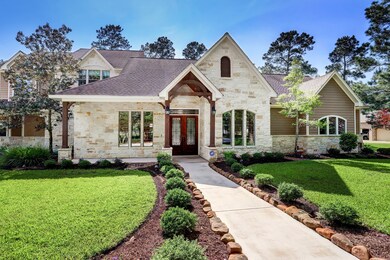 Wrought iron adorns the front double doors beneath wood beams.
