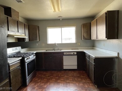 Kitchen with gas range, under cabinet range hood,