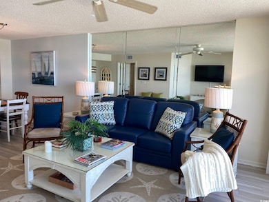 Living room with baseboards, a textured ceiling, v