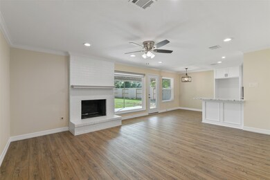 Large family room featuring a wood burning or gas