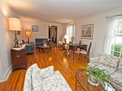 Formal living room has gas fireplace, crown moldin