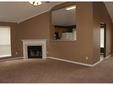 Vaulted great room looks into the kitchen and open