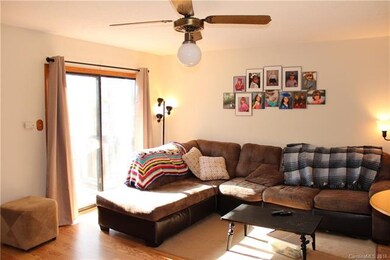 Bright living room with sliding glass doors to dec