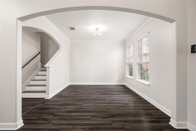 Empty room featuring ornamental molding, dark woo