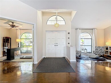 Foyer entrance with ceiling fan and plenty of natu