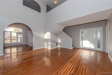 Unfurnished living room with hardwood / wood-style