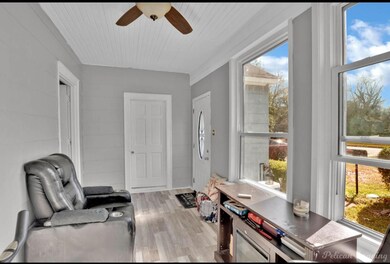 Sitting room featuring ceiling fan, light hardwood