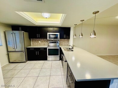 Kitchen featuring pendant lighting, a raised ceili