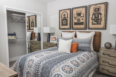 Carpeted bedroom featuring a closet