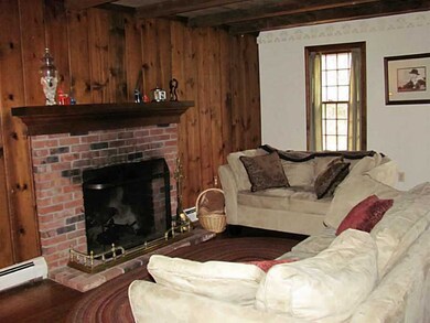 Living Room. Wood beams, pine floors, brick firepl