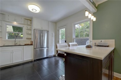 Kitchen featuring stainless steel fridge, open sh