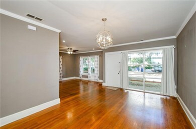 Unfurnished living room featuring a chandelier, crown molding, wood finished floors, a ceiling fan, and recessed lighting