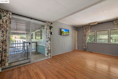 Spare room featuring wooden walls and wood finished floors