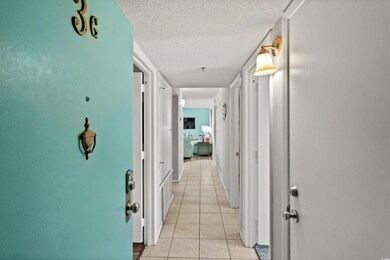 Corridor featuring light tile patterned flooring a