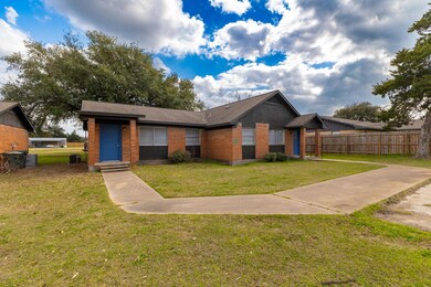 View of front of property featuring fence, a fron