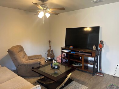 Living room featuring dark wood finished floors and ceiling fan